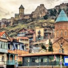 Tbilisi’s old town enchants with wooden houses and historic alleys, while Narikala Fortress rises above as the city’s ancient guardian.