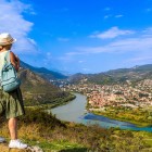 Panoramic view over Mtskheta, the ancient capital of Georgia, where the Aragvi and Kura rivers meet among green hills and historic churches that tell the country’s millennial story.
