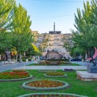 The Yerevan Cascade complex with flower gardens, modern sculptures and monumental stairways leading to the memorial, surrounded by tree-lined avenues in the Armenian capital.