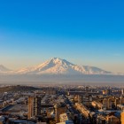 Scenic sunrise view of Mount Ararat rising majestically above the Sebastia-Malatia district of Yerevan, Armenia, as the first morning light gently illuminates the city.