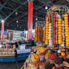 Stall at Yerevan’s GUM Market filled with dried fruits, traditional sweets and local specialties, showcasing vibrant colors and authentic flavors in the Armenian capital.