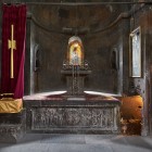 Interior of Khor Virap Monastery with a stone altar, sacred icons and soft lighting creating a peaceful and spiritual atmosphere typical of Armenian architecture.