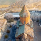 Khor Virap Monastery, in Armenian style, features tuff stone, a compact layout and a conical dome. Clean, harmonious lines within the landscape.