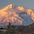 Spectacular view of Khor Virap Monastery with majestic Mount Ararat in the background, bathed in golden light and iconic Armenian landscapes.