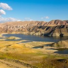 Evocative landscape of the Azat basin in the Ararat region of Armenia, with colorful rolling hills, water reflections and wind-shaped mountains