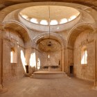 Interior of Noravank Monastery, Armenia: elegant medieval architecture with arches and central dome, natural light and a mystical atmosphere of history and spirituality.