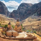 Noravank Monastery in Vayots Dzor canyon, Armenia: medieval red stone complex set among dramatic mountains, a symbol of history and spirituality.