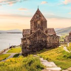 Sevanavank Monastery on Lake Sevan, Armenia: Surp Arakelots and Surp Astvatsatsin churches on a scenic hill, surrounded by crystal-clear waters and breathtaking views.