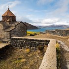 Sevanavank Monastery on Lake Sevan, Armenia: Surp Arakelots and Surp Astvatsatsin churches on a scenic hill, surrounded by crystal-clear waters and breathtaking views.