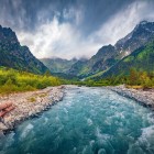 Rushing river through the mountains of Upper Svaneti, Georgia. A wild and breathtaking landscape of peaks, forests and pristine Caucasus nature.