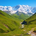 Mountain landscape of Svaneti with green valleys and snow-capped Caucasus peaks. Pristine nature and breathtaking scenery perfect for trekking and adventure.