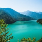 Panoramic view of the Enguri River and Jvari reservoir in Upper Svaneti, with turquoise waters and green mountains. A stunning natural landscape in Georgia.