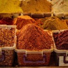 Colorful assortment of Georgian spices at Kutaisi market, a symbol of local cuisine. Rich aromas and authentic flavors among lively market stalls.