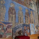 Medieval frescoes in Akhtala Monastery, Armenia, depicting sacred figures on stone walls, reflecting the religious and artistic traditions of the Caucasus.