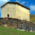 Entrance on the west side, with a chapel to the southwest, the stone church features solid arches supported by columns rising from the floor.