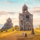 Haghpat Monastery features medieval Armenian stone architecture, with compact volumes, conical domes and pitched roofs, decorated with carved crosses and geometric motifs.