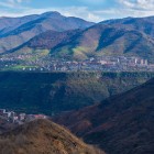 Panoramic view of Alaverdi, Armenia, nestled among deep gorges and mountains, with the town stretching along the river in a scenic landscape.