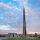 Armenian Genocide memorial monument at Tsitsernakaberd, Yerevan, featuring the soaring obelisk and circular memorial set in a scenic panoramic landscape.