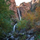 The spectacular Gveleti waterfalls in the Dariali Gorge near Kazbegi flow through the Caucasus peaks, creating a stunning landscape perfect for nature and trekking lovers.