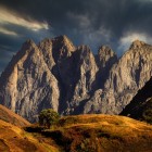 Spectacular rocky peaks of Mount Chaukhebi rise amid light and shadow, dominating wild and evocative landscapes in the heart of the Georgian Caucasus.