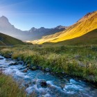 A crystal-clear stream flows through alpine meadows and gentle valleys at the foot of Mount Chaukhebi, creating a stunning landscape in the heart of the Georgian Caucasus.