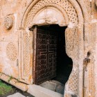 Open entrance of the Gergeti Holy Trinity Church, perched at 2,170 m below Mount Kazbek, among the most evocative panoramas of the Georgian Caucasus.