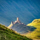 Ruins of an ancient fortress in Truso Valley, perched on a panoramic hill amid the vast mountain landscapes of the Georgian Caucasus.