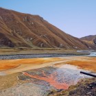 Reddish travertines and mineral springs in Truso Valley, where iron oxide colors the ground creating remarkably unusual natural scenery.