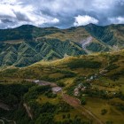View over the village of Kvesheti, a small mountain settlement set among green valleys and Caucasus ridges along the historic Georgian Military Highway.