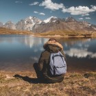 On the shores of Koruldi Lake, among clear reflections and silence, the view drifts towards the Caucasus mountains in a timeless landscape.