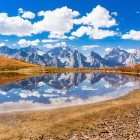 Koruldi Lake above 2,700 meters, between open skies and Svaneti mountains. A simple landscape where the horizon fades into water, light and silence.