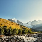 At the beginning of the panoramic platform of Chkhunderi Pass, the trail opens toward the crossing point leading to the ford of the Adishchala River.