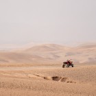 Quad bike standing still in the silence of the Agafay Desert, among dirt tracks, soft hills and the arid landscapes of Morocco.