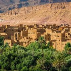 Tinghir lies between palm groves and rocky mountains in southern Morocco, famous for the Todra Gorges and its mud-brick villages nestled within the oasis.