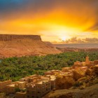 Spectacular sunset over the Dadès Valley, where palm groves, Berber villages and rocky canyons glow golden beneath the Moroccan sky.