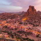 View of Tafraout at sunset, among ochre-coloured houses, the Anti-Atlas Mountains and the famous rock known as Napoleon’s Hat.