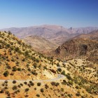 Panoramic road through the Anti-Atlas Mountains in southern Morocco, among arid valleys, winding roads and landscapes stretching to the horizon.