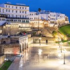 The historic walls of Tangier light up the evening among elegant squares, ancient bastions and timeless atmospheres in northern Morocco.