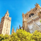 The majestic Seville Cathedral and the Giralda rise above lush orange trees, timeless symbols of a city where history, art and tradition come together.