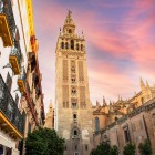 At sunset, the Giralda towers over Seville's historic center, surrounded by charming streets and centuries-old monuments that reflect Andalusia's rich heritage.