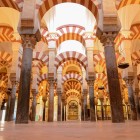 A mesmerizing forest of columns and red-and-white arches makes Cordoba's Mosque-Cathedral one of Andalusia's greatest masterpieces, blending Islamic art and history.