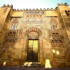 The majestic entrance of Cordoba's Mosque-Cathedral welcomes visitors with Moorish details, centuries of history and an extraordinary artistic heritage in Andalusia.