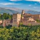 The Alhambra overlooks Granada with its walls, towers and Nasrid palaces beneath the Sierra Nevada. A masterpiece of Islamic architecture and Andalusia's timeless icon.