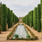 The Gardens of the Alcázar in Córdoba enchant visitors with cypress-lined paths, reflecting pools and elegant fountains. A peaceful oasis filled with Andalusian charm.