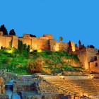 Malaga's Alcazaba rises above the Roman Theatre with its illuminated walls. A place where Moorish and Roman heritage meet in the heart of Andalusia.
