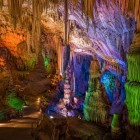 St. Michael's Cave amazes with towering stalactites and stalagmites enhanced by dramatic lighting, revealing one of Gibraltar's most fascinating natural wonders.