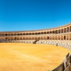 Ronda's Bullring, one of the oldest in Spain, impresses with its vast circular arena and elegant stone arcades, a symbol of Andalusian tradition.