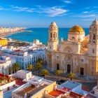 Santa Cruz on the Sea Cathedral rises above Cádiz's historic centre with its golden dome, overlooking the Atlantic among whitewashed streets and elegant squares.