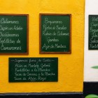 The chalkboard menus outside a traditional tavern in Cadiz showcase tapas and fresh seafood specialties, inviting visitors to discover authentic Andalusian culinary traditions.