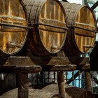 Ancient oak barrels preserve Sherry wine during its long ageing process through the traditional Solera system, a hallmark of Jerez's renowned winemaking heritage.